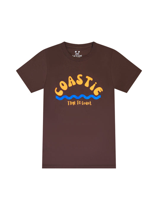 Bark or brown laydown of graphic t-shirt in organic cotton made in USA. Homegrown t-shirt with large graphic, of the word Coastie in orange with blue waves at the bottom. Small Time to Coast Logo in Orange.
