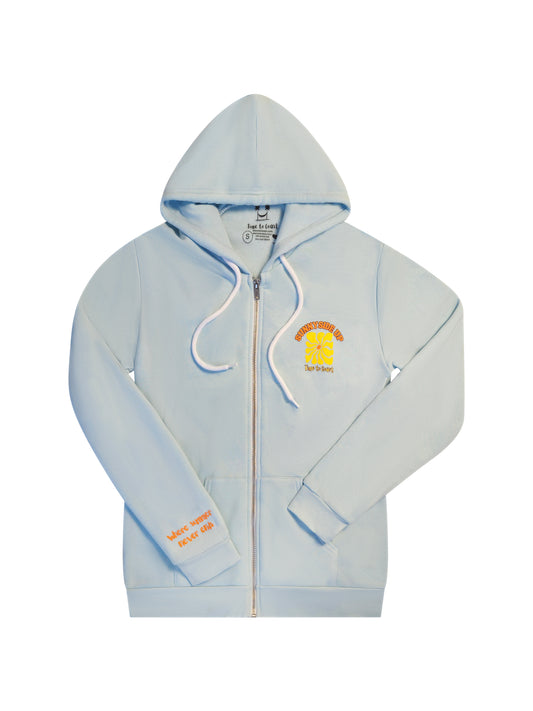 Laydown showing the front the light blue Florida Fleece Zip Front Hoodie. The graphic is the Time to Coast Sunnyside Up Sun in orange and yellow. Large graphic on back with small left chest graphic. One sleeve has the words where summer never ends