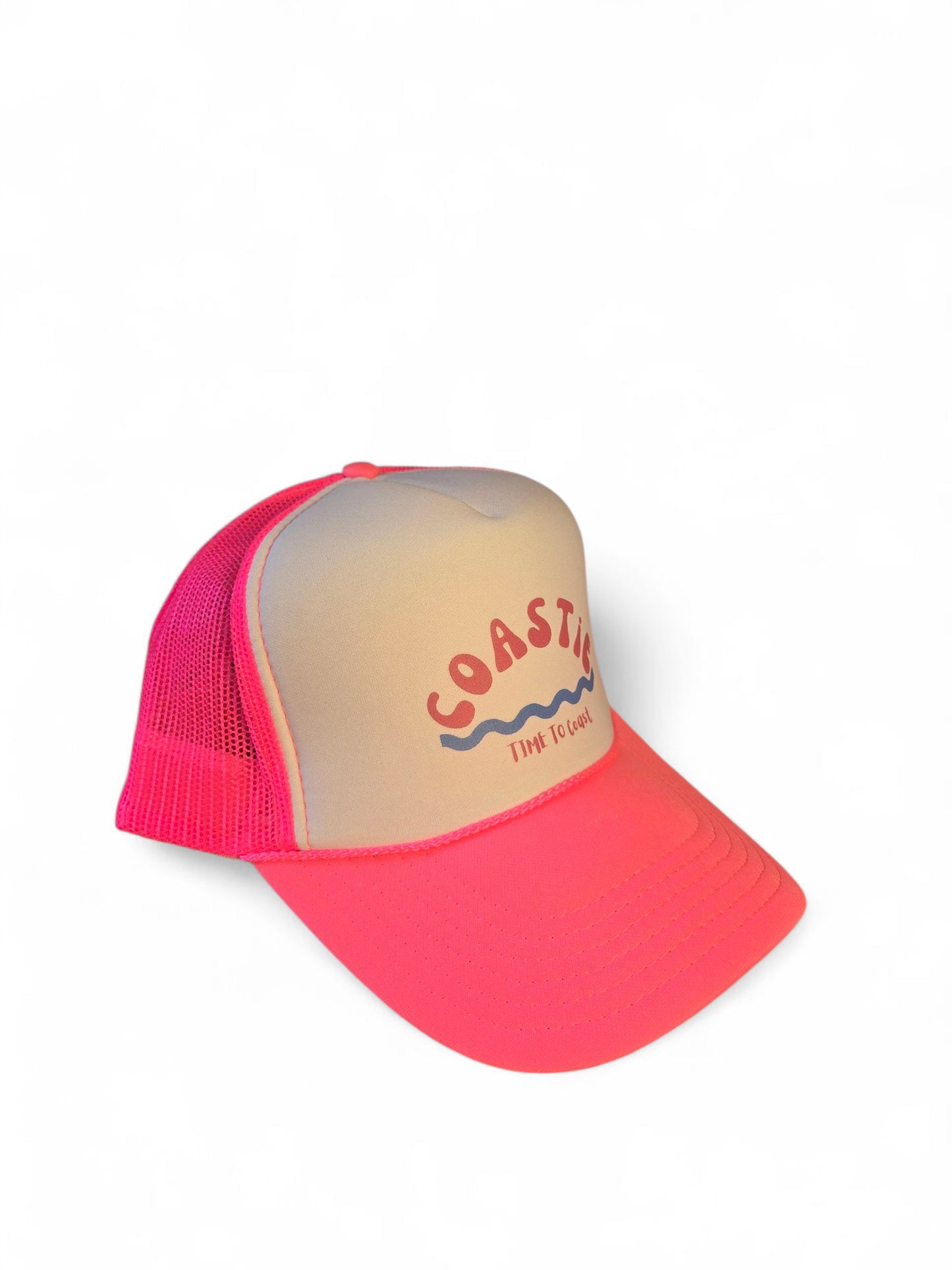 Side view laydown of a foam high profile trucker hat. Graphic is printed with Time to Coast Coastie with waves. Hat color is bright pink bill and mesh back with white front.