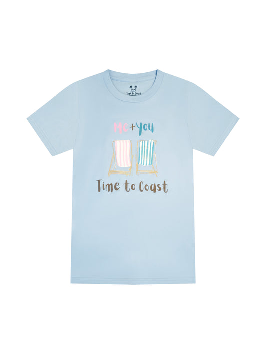 Light blue  laydown of  a woman's  t-shirt in organic cotton made in USA. Homegrown t-shirt with a large front graphic of 2 beach chairs, one pink other light blue with Me + You saying and Time to Coast Logo.