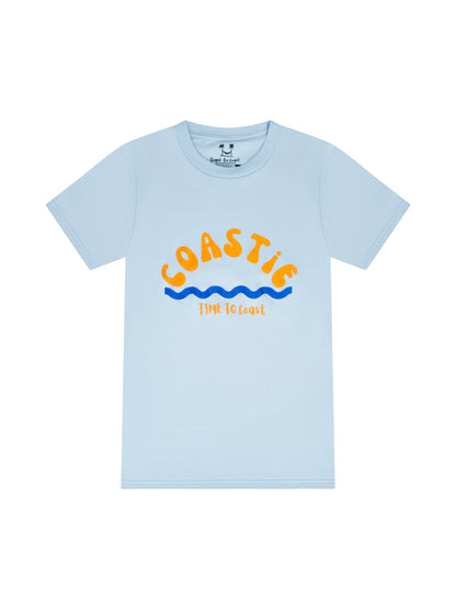 Light blue laydown of graphic  t-shirt in organic cotton made in USA. Homegrown t-shirt with large graphic, of the word Coastie in orange with blue waves at the bottom. Small Time to Coast Logo in Orange. 