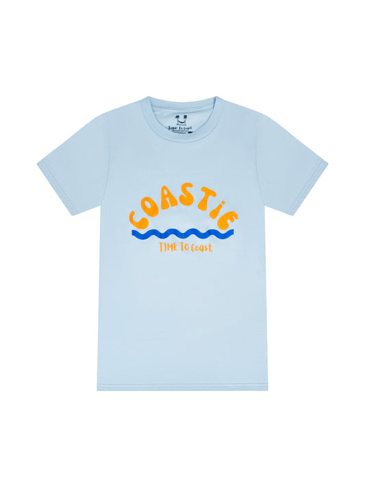 Light blue laydown of graphic  t-shirt in organic cotton made in USA. Homegrown t-shirt with large graphic, of the word Coastie in orange with blue waves at the bottom. Small Time to Coast Logo in Orange. 