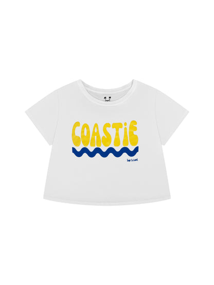 Laydown of a white Time to Coast Palm Cloth Coastie crop Tee. Coastie graphic is yellow with a blue wave. 