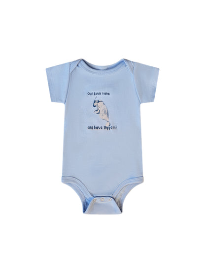Laydown of a light blue onesie with a Time to Coast playful manatee with a mask and snorkel. Slogan says our cows have flippers.  Manatee is gray with navy letters.