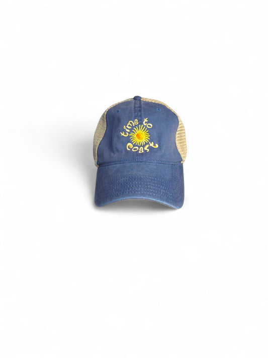 Laydown of  Time to sun low profile trucker twill hat with tan mesh back and navy washed twill. Graphic is sun with time to coast circling the sun. Embroidery is yellow.