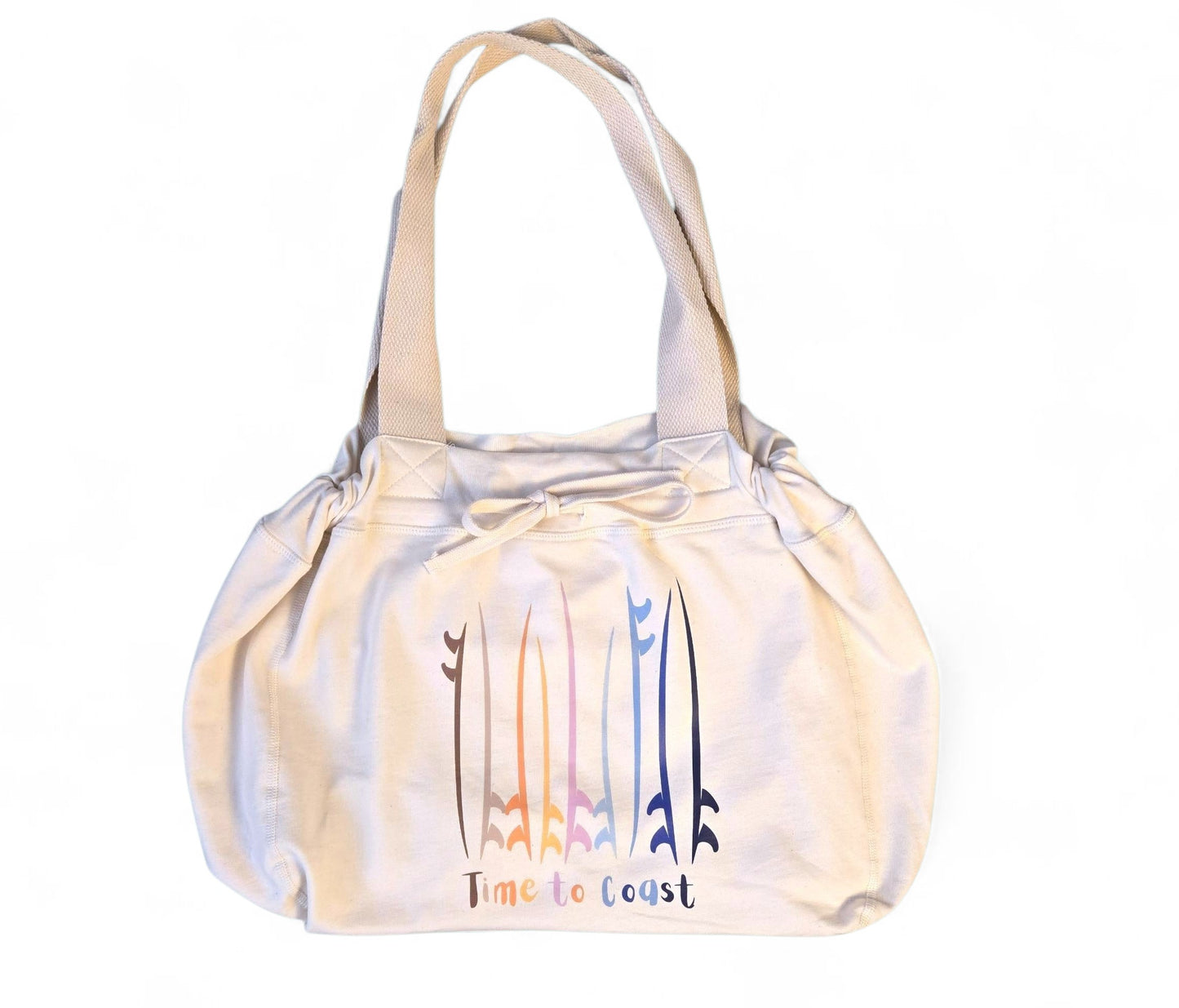 Laydown of the Florida Fleece Hobo Beach Bag, with drawstring closure. Creme colored with Time to Coast Board Meeting Graphic with multi colored surf and sup boards. 