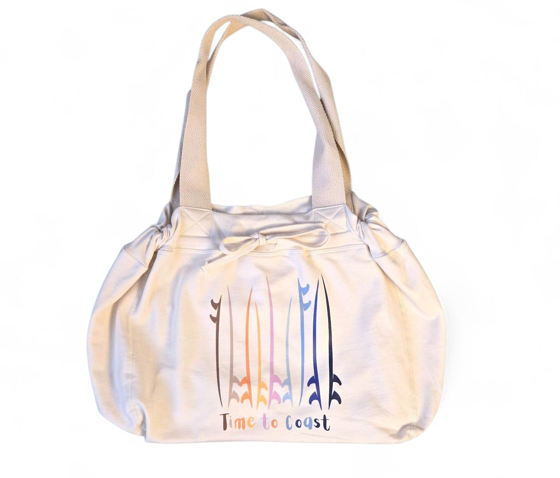 Laydown of the Florida Fleece Hobo Beach Bag, with drawstring closure. Creme colored with Time to Coast Board Meeting Graphic with multi colored surf and sup boards. 
