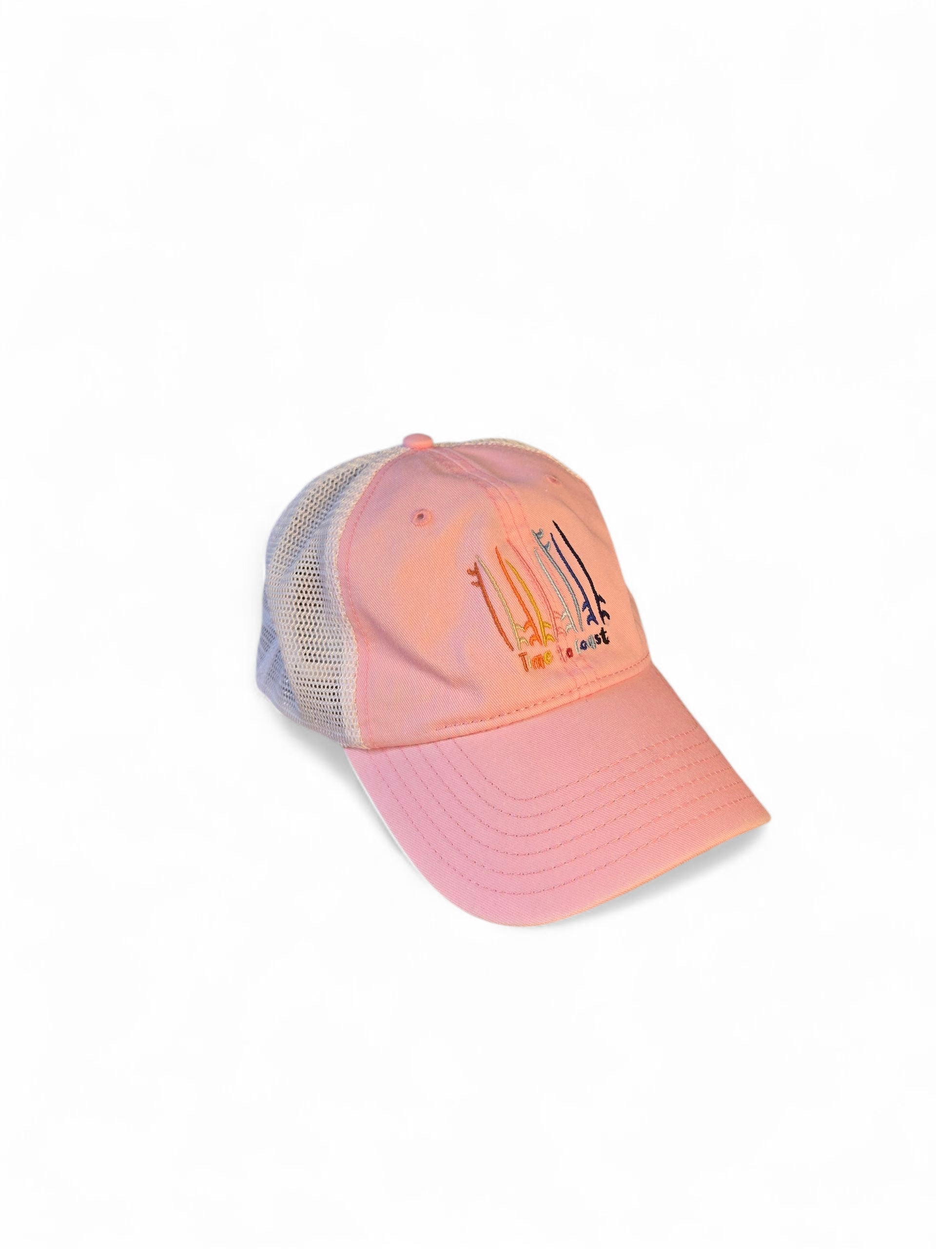Side view laydown of the Board Meeting embroidered Time to Coast washed twill pink low profile trucker hat with tan mesh back. Embroidered graphic is of surf and sup boards in multi colors.