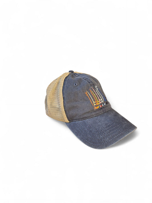 Side view laydown of the Board Meeting embroidered Time to Coast washed twill navy low profile trucker hat with tan mesh back. Embroidered graphic is of surf and sup boards in multi colors.
