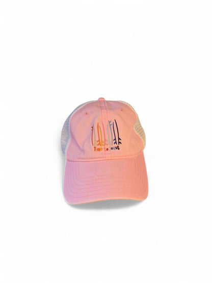 Laydown of the Board Meeting embroidered Time to Coast washed pink twill low profile trucker hat with tan mesh back. Embroidered graphic is of surf and sup boards in multi colors.
