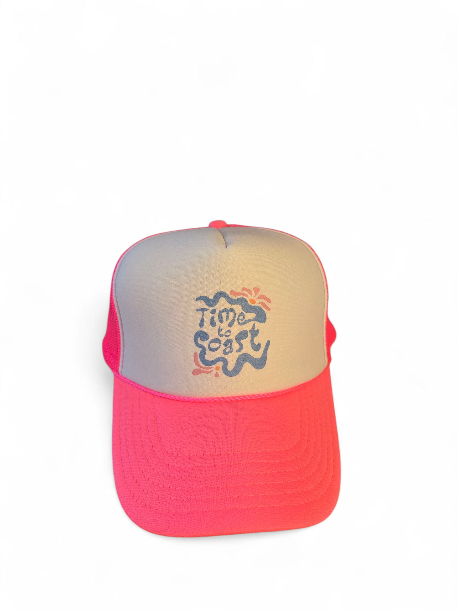 Laydown of a foam high profile trucker hat.  Graphic is printed with Time to Coast Hippy Wave. Hat color is bright pink bill and mesh back with white front. 