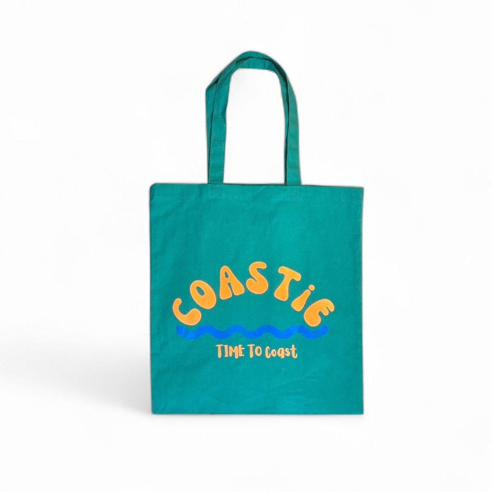 laydown of a green Market Bag.  Bag has a Coastie word graphic, wave and time to coast logo