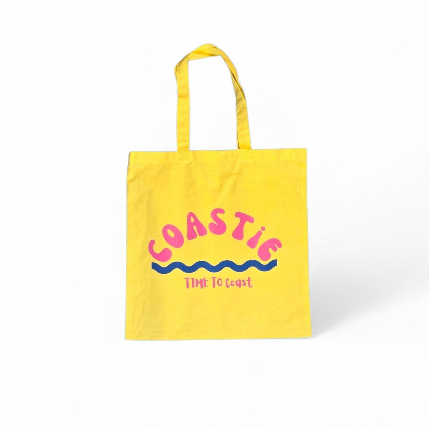 laydown of a yellow Market Bag.  Bag has a Coastie word graphic, wave and time to coast logo