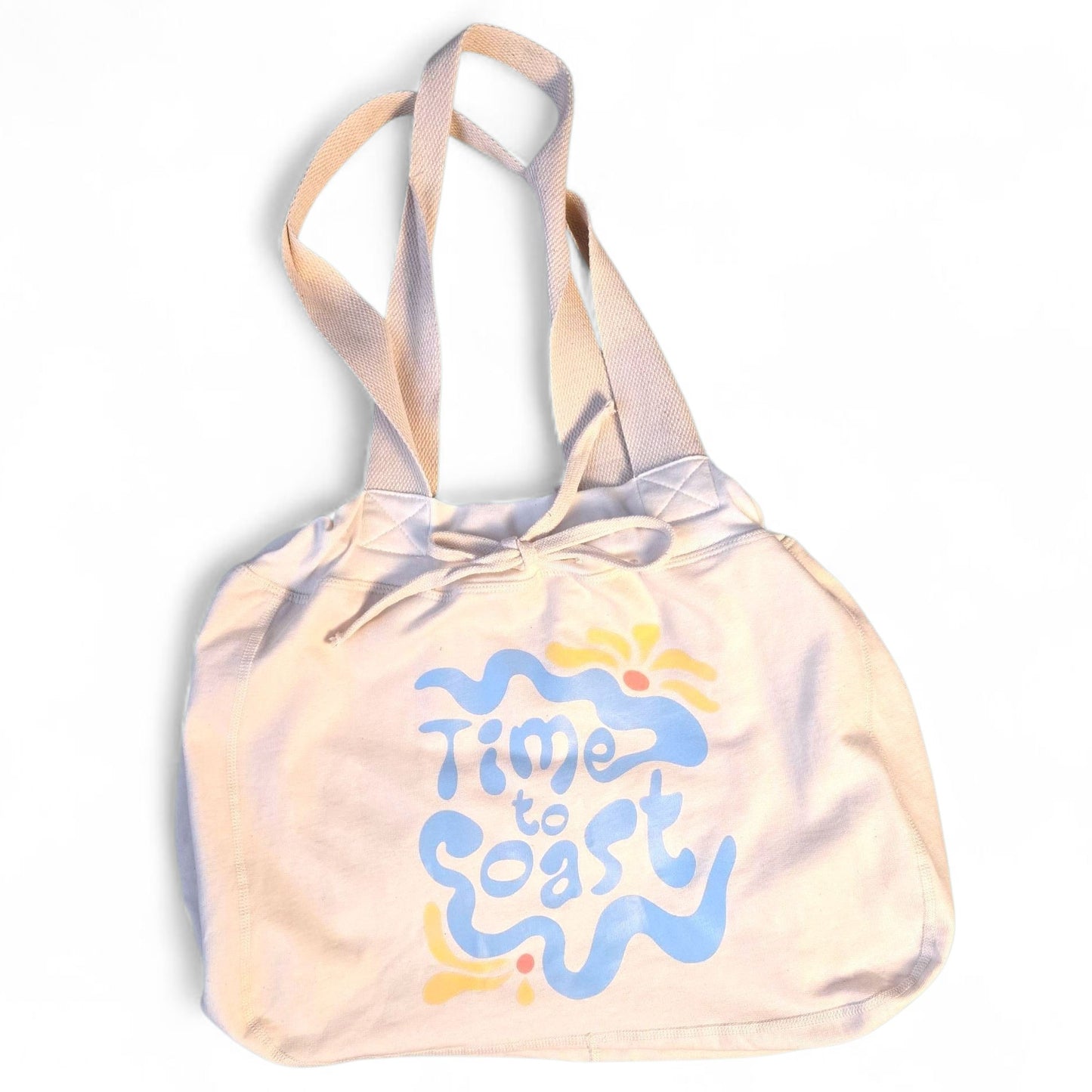 Laydown of the Florida Fleece Hobo Beach Bag, with drawstring closure. Creme colored with Time to Coast Hippy Wave Graphic in light blue and yellow. 